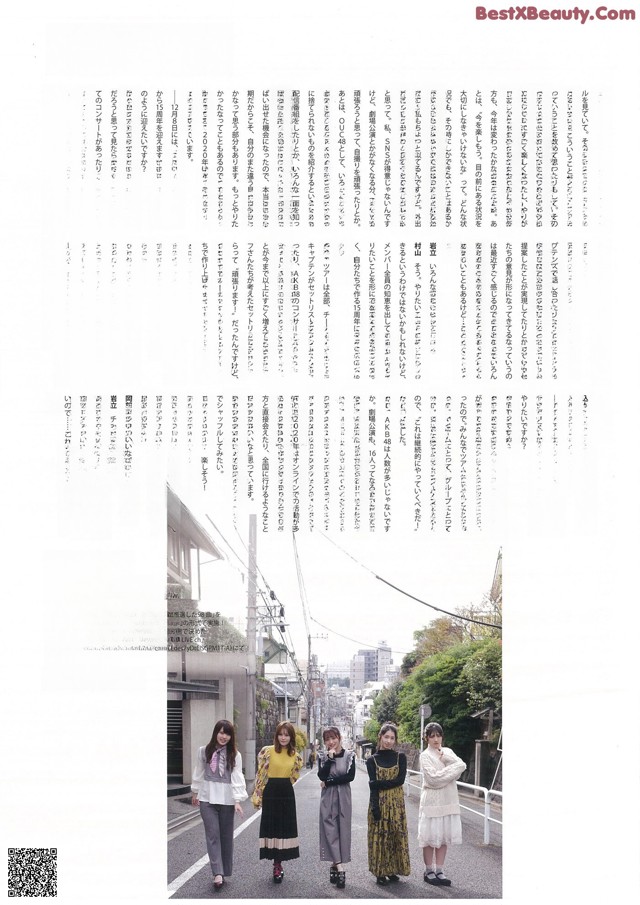 A group of women standing next to each other on a street.